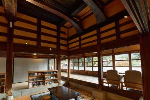 a living room with wooden ceilings and windows at kitanUOZU in Uozu