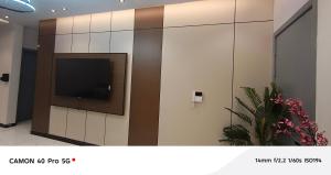 a wall with a tv in a room with flowers at Al Amer Apartment2 in Jeddah