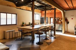 a kitchen with a large wooden table and chairs at kitanUOZU in Uozu +24 photos