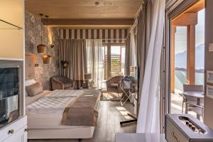 a bedroom with a large bed and a balcony at Hotel Villa Madruzzo in Trento