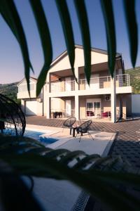 a building with a pool and a bench in front of it at Villa Laguna Mostar in Mostar