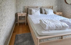 a bedroom with a white bed with two night stands at Amazing Home In Tingsryd With Wifi in Ryd