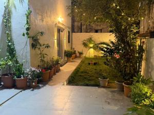 a courtyard with potted plants in a building at Spacious Garden Home in Aurangabad