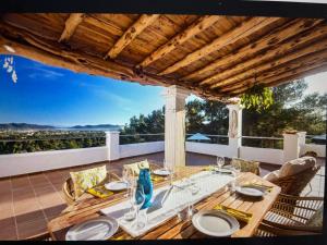 a dining table on a patio with a view at Villa Casiopea in Illes Balears