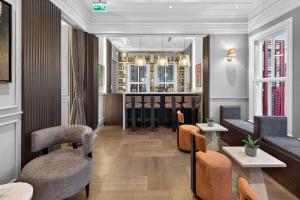 a lobby with chairs and tables and a bar at Arbor Hotel - Signature Collection in Istanbul