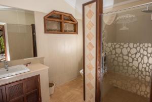 a bathroom with a shower and a sink and a toilet at Fig Tree Camp - Maasai Mara in Talek +46 photos