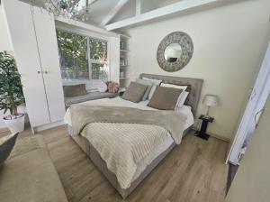 a bedroom with a large bed and a window at African Diamond - Date Night Suite in Benoni +69 photos