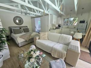 a living room with a couch and a bed at African Diamond - Date Night Suite in Benoni