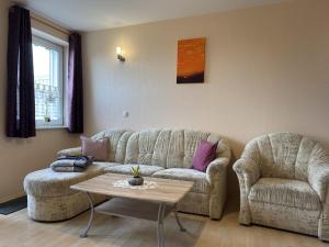 a living room with two couches and a coffee table at Charmante Ferienwohnung mit Garten in Wiek in Wiek auf Rügen +138 photos