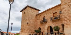 a large brick building with two balconies and a street light at Cielos in Celadas