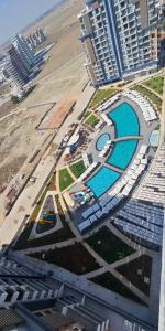 an aerial view of a resort with a pool and buildings at Riverside studio in Iskele in Dherinia +5 photos