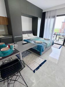 a bedroom with a bed and a table with a table at Riverside studio in Iskele in Dherinia
