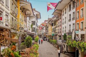 a city street with buildings and people walking down the street at Appartment floor 1 in Thun