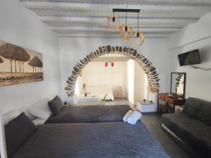 a living room with a couch and an archway at VILLA VASILIS ORNOS in Mikonos