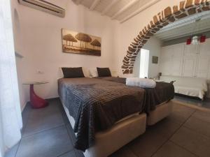 a bedroom with a large bed in a room at VILLA VASILIS ORNOS in Mikonos