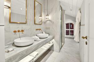 a bathroom with two sinks and two mirrors at Arbor Hotel - Signature Collection in Istanbul +90 photos