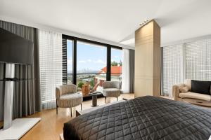 a bedroom with a large bed and a large window at Arbor Hotel - Signature Collection in Istanbul