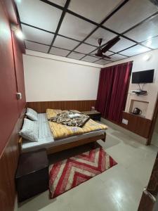 a bedroom with a bed and a red curtain at Abhi house Naddi in McLeod Ganj