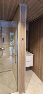 a bathroom with a shower and a sink at Cabin With Dock By Otra In Setesdal in Bygland +17 photos