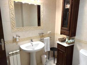a bathroom with a sink and a mirror at A CALZADA in Cambados +24 photos