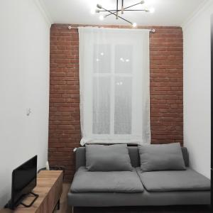 a living room with a couch and a window at Klonowicza UP in Leszno