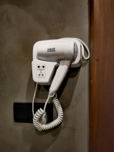 a white hair dryer is attached to a wall at Liora Lodge Ella in Ella