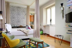 a bedroom with a bed and a chair and a window at Residenza delle Città in Milan