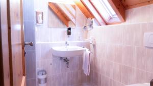 a small bathroom with a sink and a window at Hotel Spinnerhof in Sasbachwalden +26 photos