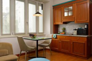 a kitchen with a table and chairs in a kitchen at Residenza delle Città in Milan