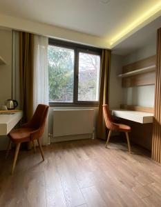 a room with two chairs and a window at Frezya Family Hotel in Istanbul