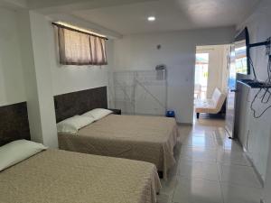 a hotel room with two beds and a window at Apartamentos Sound Bay Beach in San Andrés