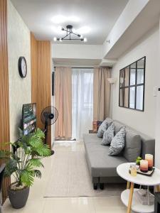 a living room with a couch and a table at Chic Urban Escape at S Residence Tower 3 in Manila