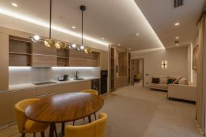 a kitchen with a wooden table and a dining room at Apart Hotel Istaravshan in Tashkent