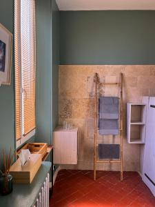 a bathroom with a shower with a towel rack at La maison Gerval in Bédoin