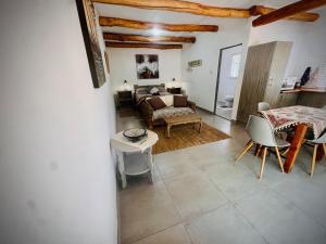 a living room with a bed and a table at Intimate Studio for Two at Hebron Estate in Piketberg