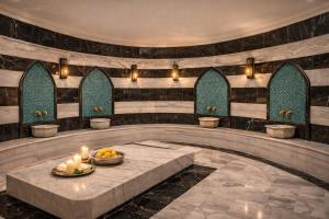 a lobby with a table with candles on it at Alodger Sirius Town Lara in Aksu