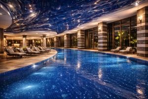 a swimming pool in a hotel with a ceiling at Alodger Sirius Town Lara in Aksu