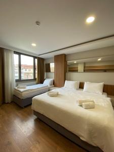 a bedroom with two beds and a large window at Frezya Family Hotel in Istanbul +74 photos