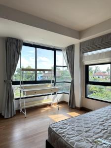 a bedroom with a pool table in front of windows at Msthouse in Ban Bang Phun