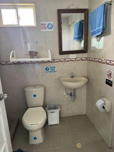 a bathroom with a toilet and a sink and a mirror at Apartamentos Sound Bay Beach in San Andrés +35 photos