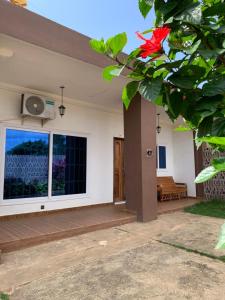 a house with a large window and a patio at 2 chambres salon au calme in Porto-Novo