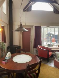 a living room with a table and a dining room at Selatuinen in Appelscha