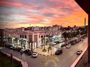 a city with cars parked in a parking lot at Marchica bay 8 holiday Apartment in Nador