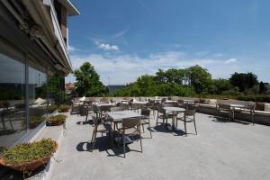a group of tables and chairs on a patio at Porta Altinia Suites in Treviso