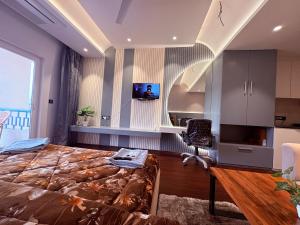 a bedroom with a large bed and a desk at Luxury Couple Friendly Studio in Dehradun