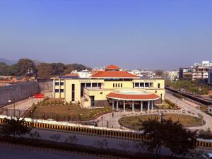 a large yellow building with a red roof at Luxury Couple Friendly Studio in Dehradun