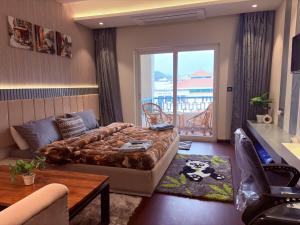 a hotel room with a bed and a balcony at Luxury Couple Friendly Studio in Dehradun