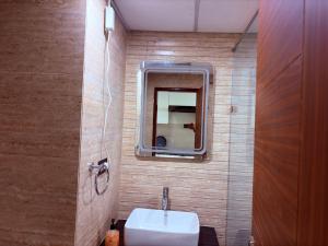 a bathroom with a sink and a mirror at Luxury Couple Friendly Studio in Dehradun +15 photos