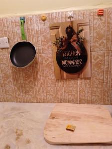 a wooden cutting board and a sign on a wall at MSL Suites Apartment in Naivasha