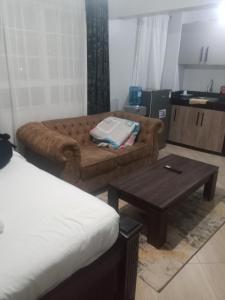 a living room with a couch and a coffee table at MSL Suites Apartment in Naivasha